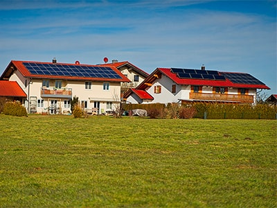 Solar modules mounted on household rooftops.
